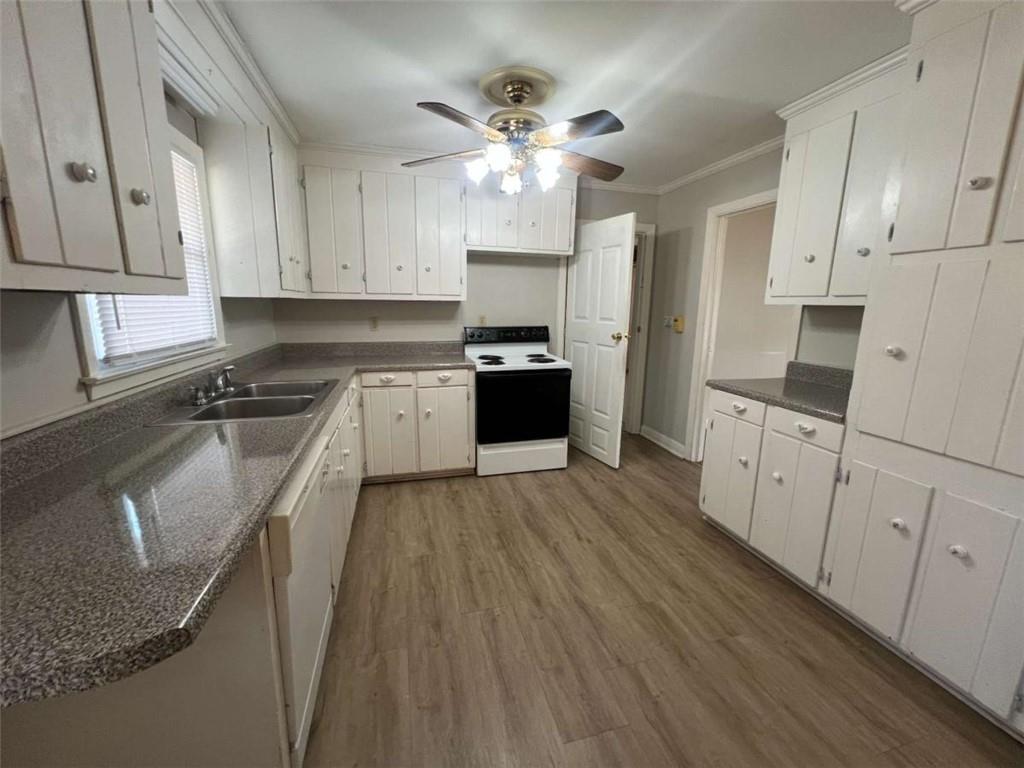 109 Chief Vann Drive Southwest Rome, GA 30165 - Photo 4 of 15 a kitchen with granite countertop a stove top oven a sink dishwasher and a refrigerator with wooden floor