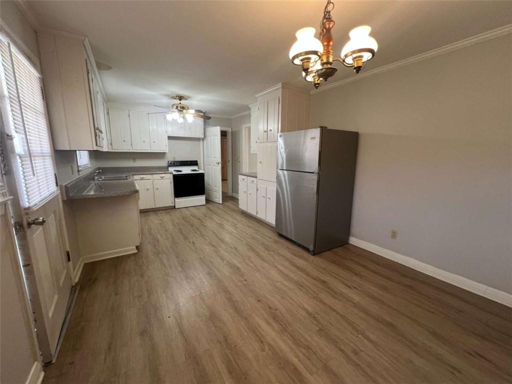 109 Chief Vann Drive Southwest Rome, GA 30165 - Photo 6 of 15 a view of a kitchen with wooden floor and a refrigerator