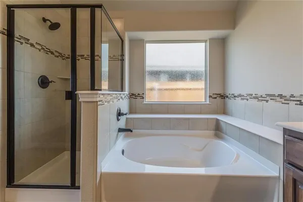 a bathroom with a bathtub and a window