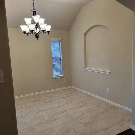 a kitchen with kitchen island granite countertop a sink a counter space appliances and cabinets