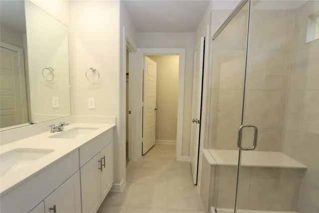 a bathroom with a shower sink and mirror