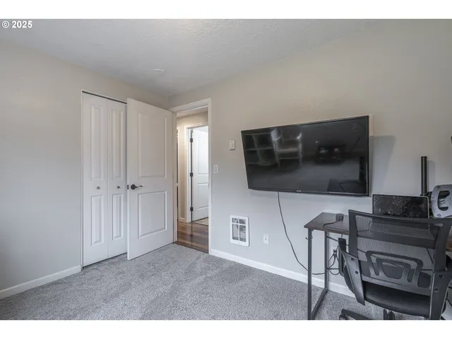 a living room with a furniture and a flat screen tv