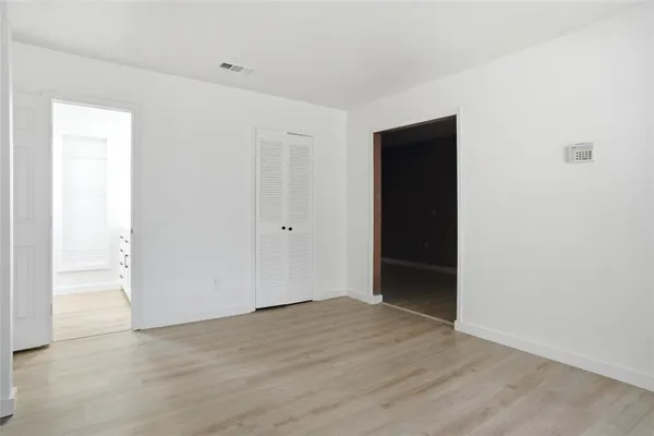 an empty room with wooden floor