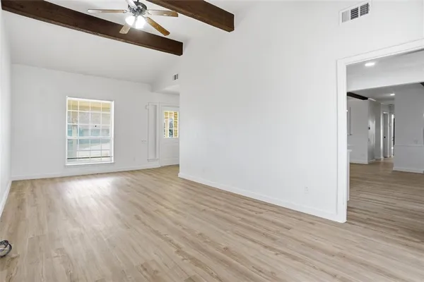 wooden floor in an empty room with a window
