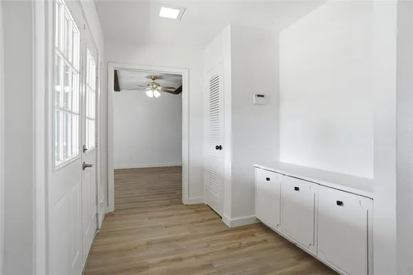 a view of a hallway with wooden floor