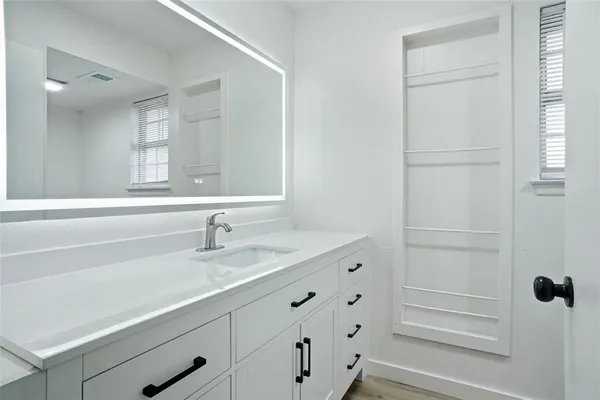 a bathroom with a sink and a mirror