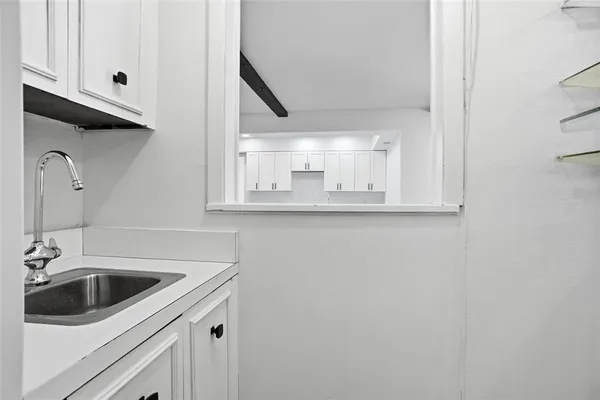 a kitchen with a sink and cabinets