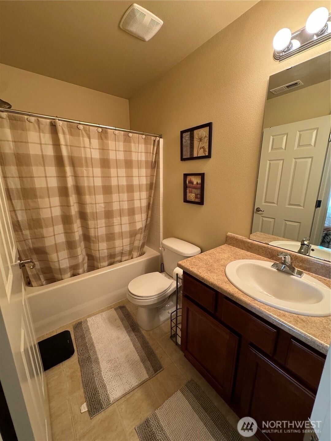 1175 Swan Loop DuPont, WA 98327 - Photo 14 of 34 a bathroom with a sink a toilet a mirror and shower curtain