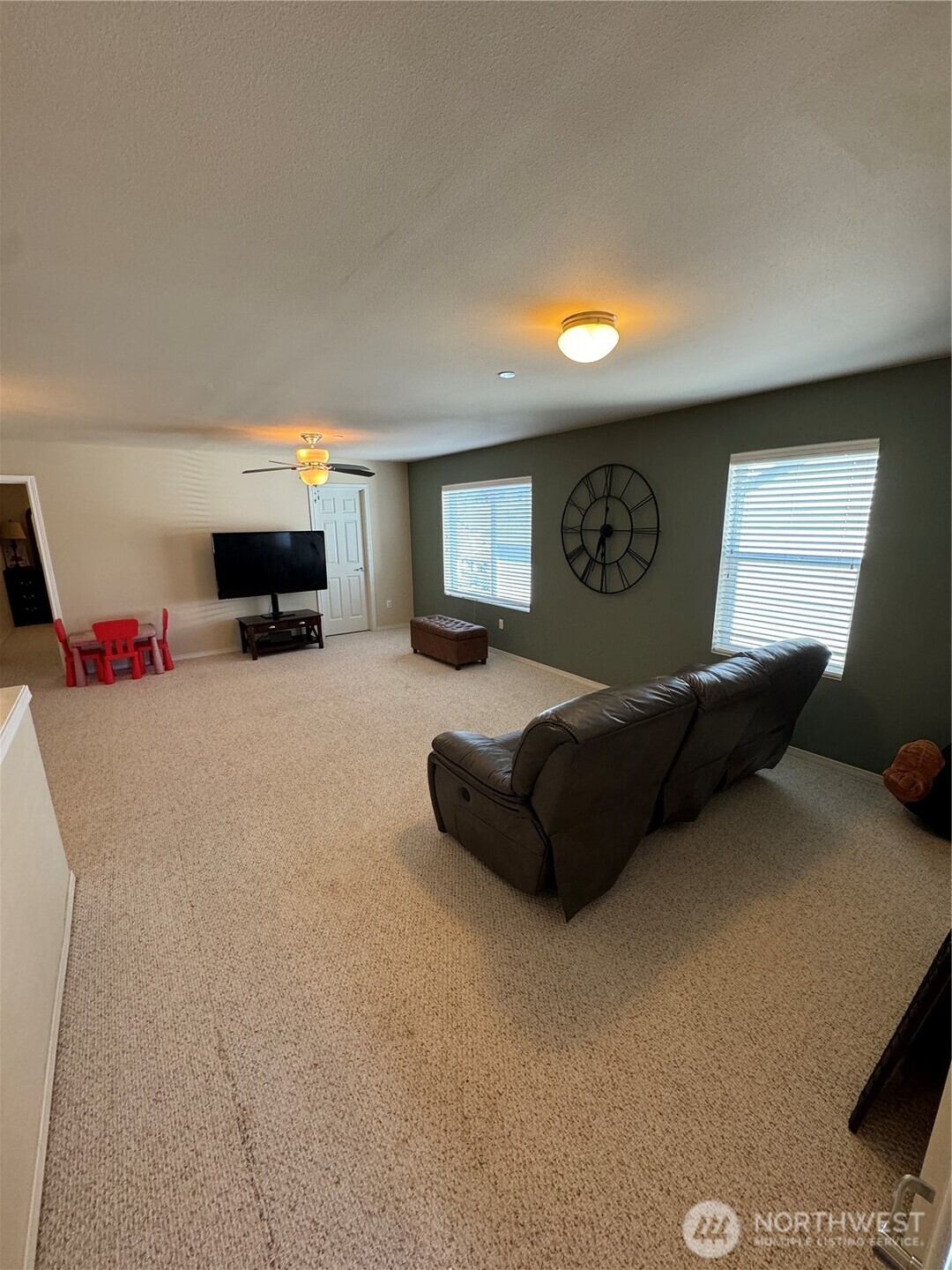 1175 Swan Loop DuPont, WA 98327 - Photo 18 of 34 a living room with furniture and a flat screen tv