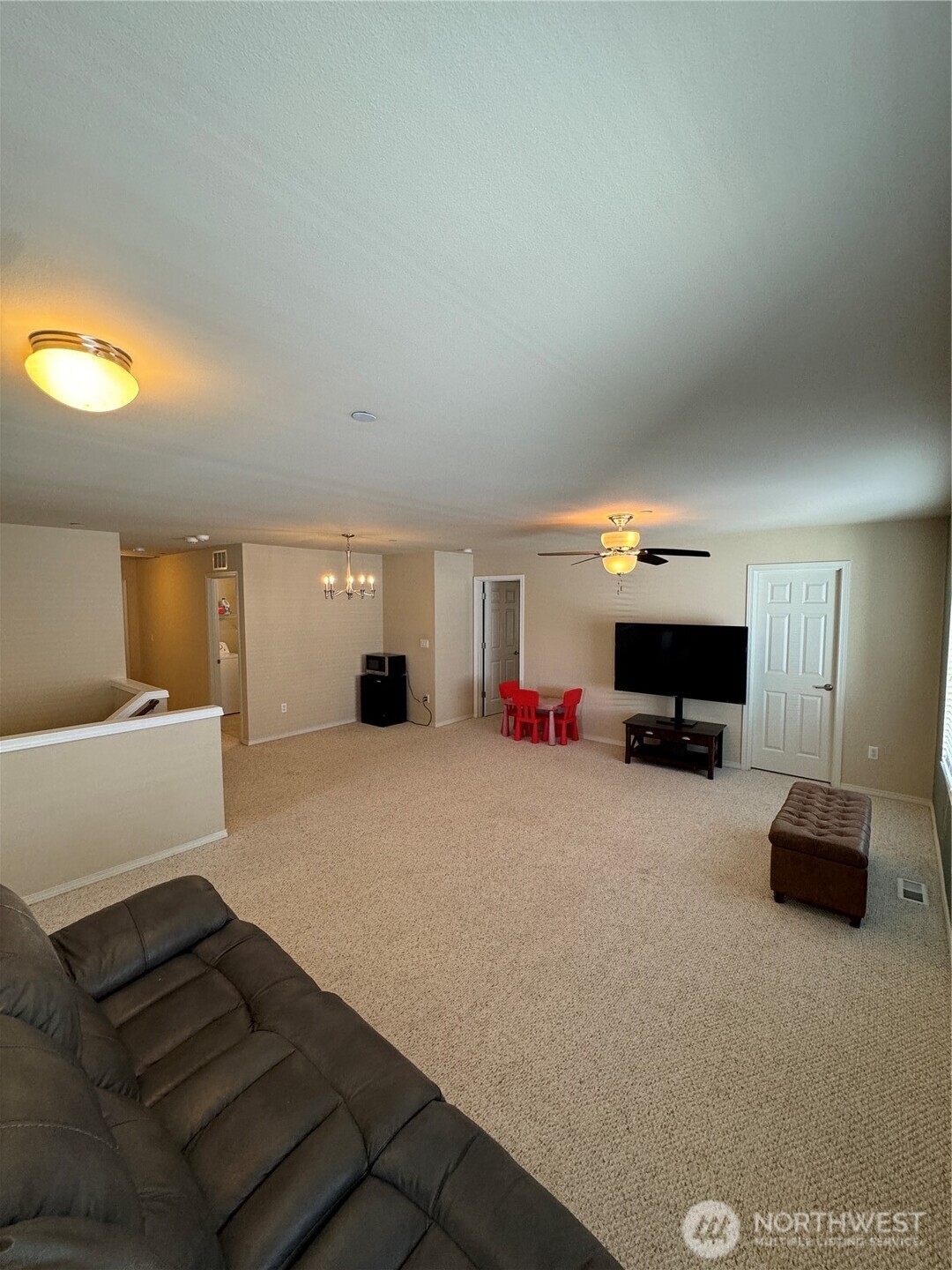 1175 Swan Loop DuPont, WA 98327 - Photo 19 of 34 a living room with furniture a flat screen tv and a fireplace