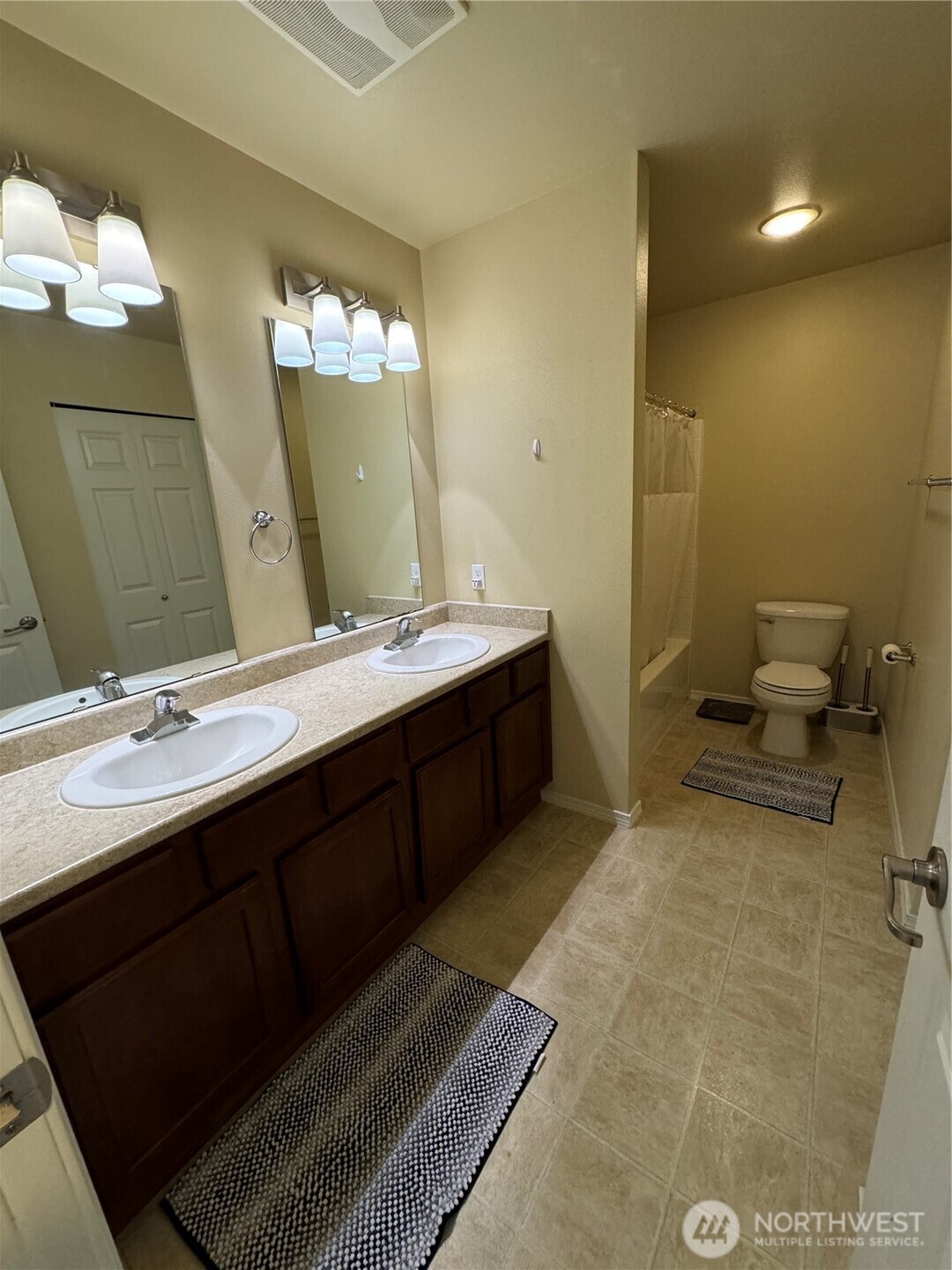 1175 Swan Loop DuPont, WA 98327 - Photo 21 of 34 a bathroom with a double vanity sink and a mirror