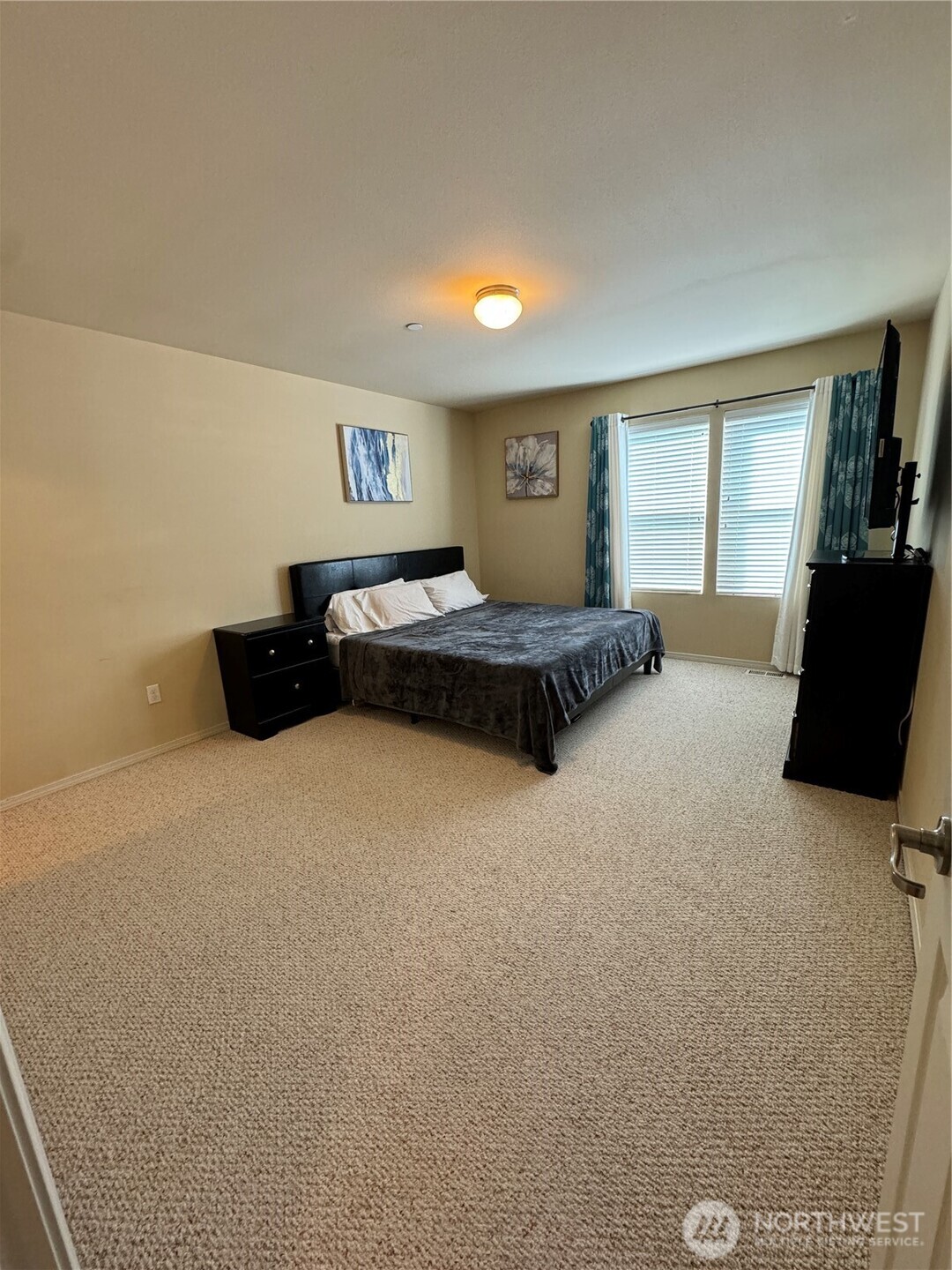 1175 Swan Loop DuPont, WA 98327 - Photo 22 of 34 a bedroom with a bed and wooden floor