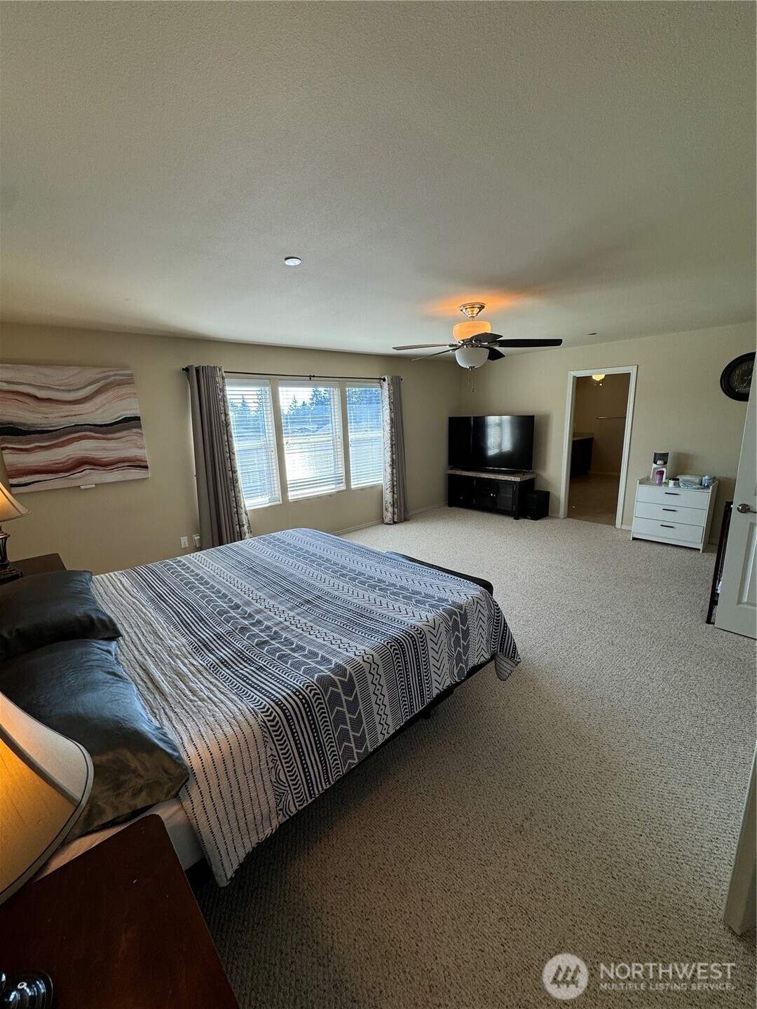 1175 Swan Loop DuPont, WA 98327 - Photo 25 of 34 a spacious bedroom with a bed and a television