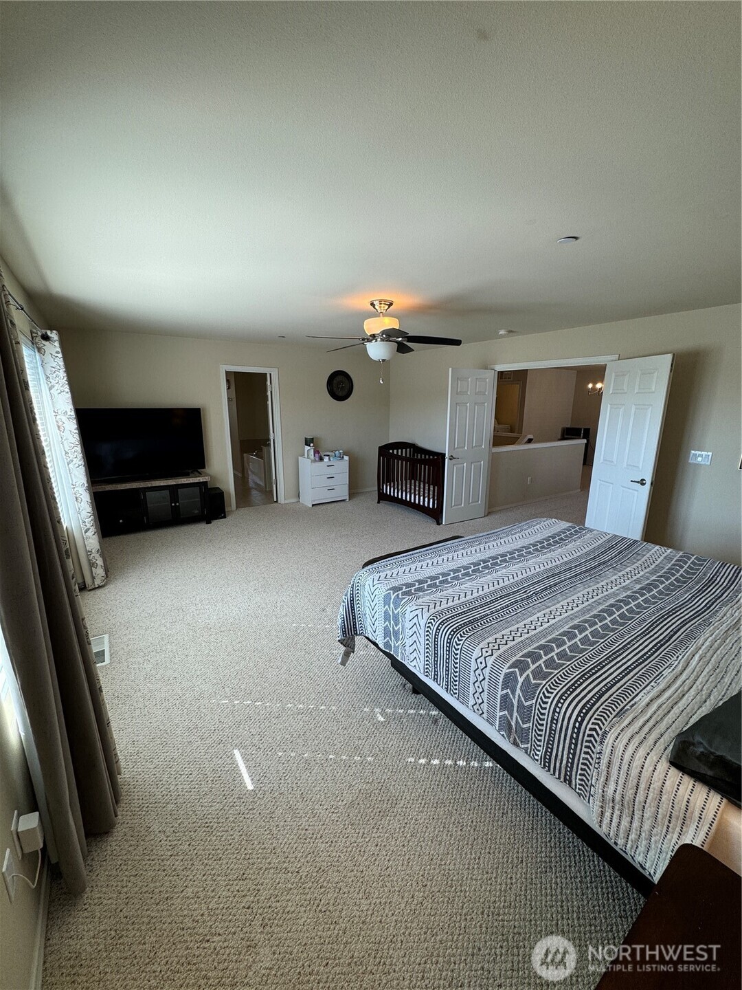 1175 Swan Loop DuPont, WA 98327 - Photo 26 of 34 a spacious bedroom with a bed and a couch