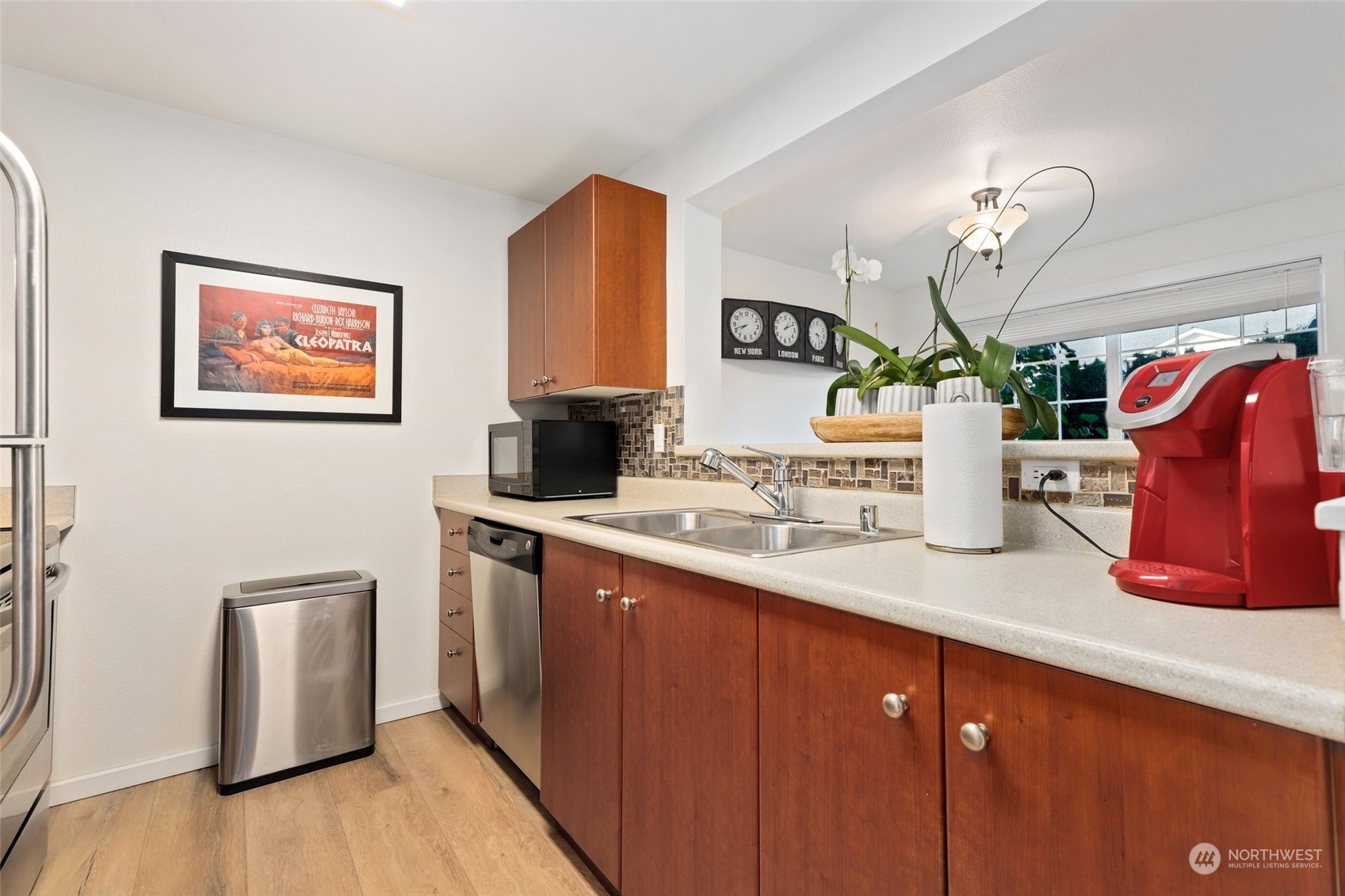 12404 East Gibson Road, Unit J103 Everett, WA 98204 - Photo 11 of 40 a kitchen with stainless steel appliances granite countertop a sink dishwasher a refrigerator and a stove with wooden floor