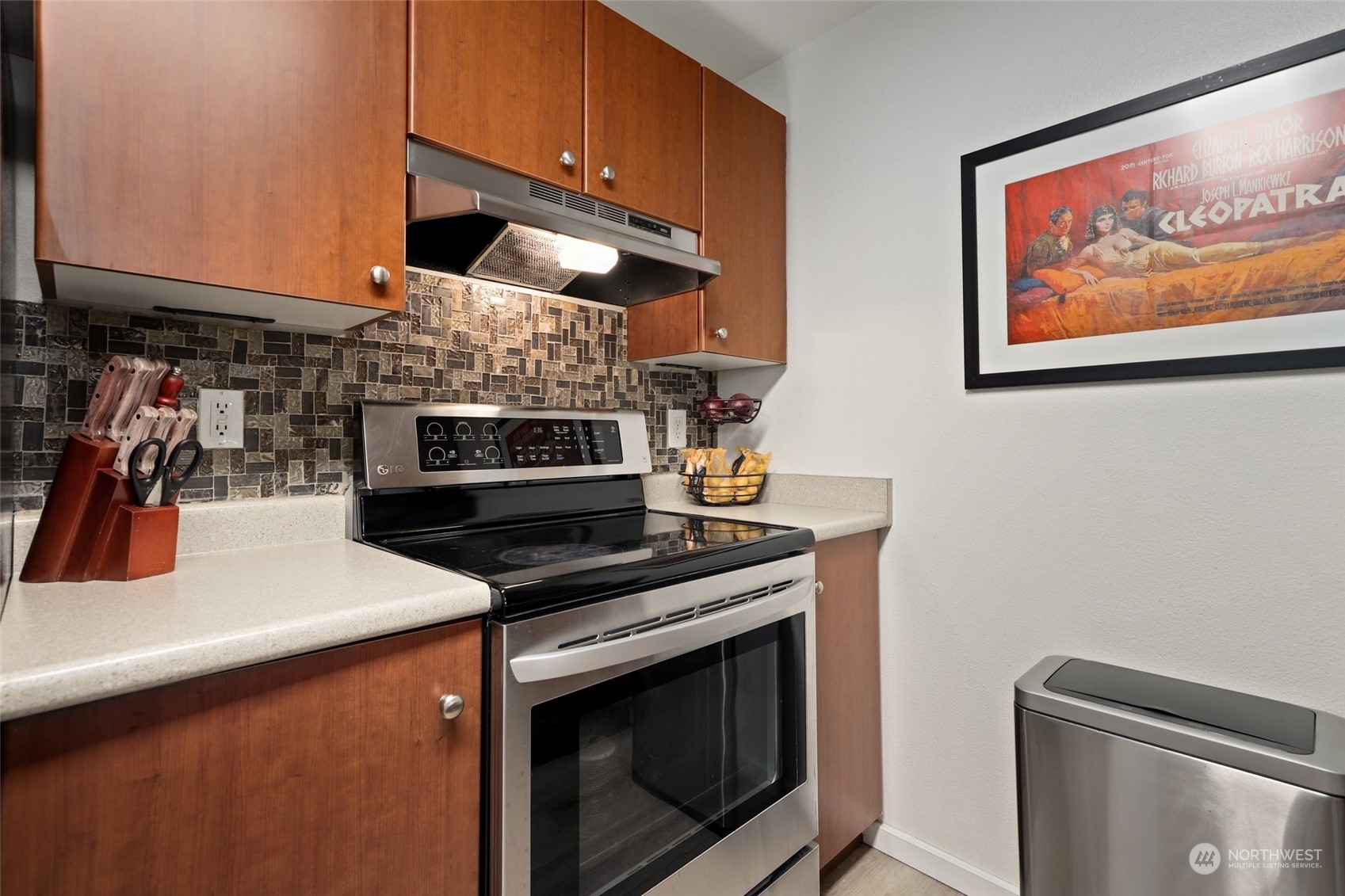 12404 East Gibson Road, Unit J103 Everett, WA 98204 - Photo 12 of 40 a kitchen with stainless steel appliances wooden floor sink and wooden cabinets