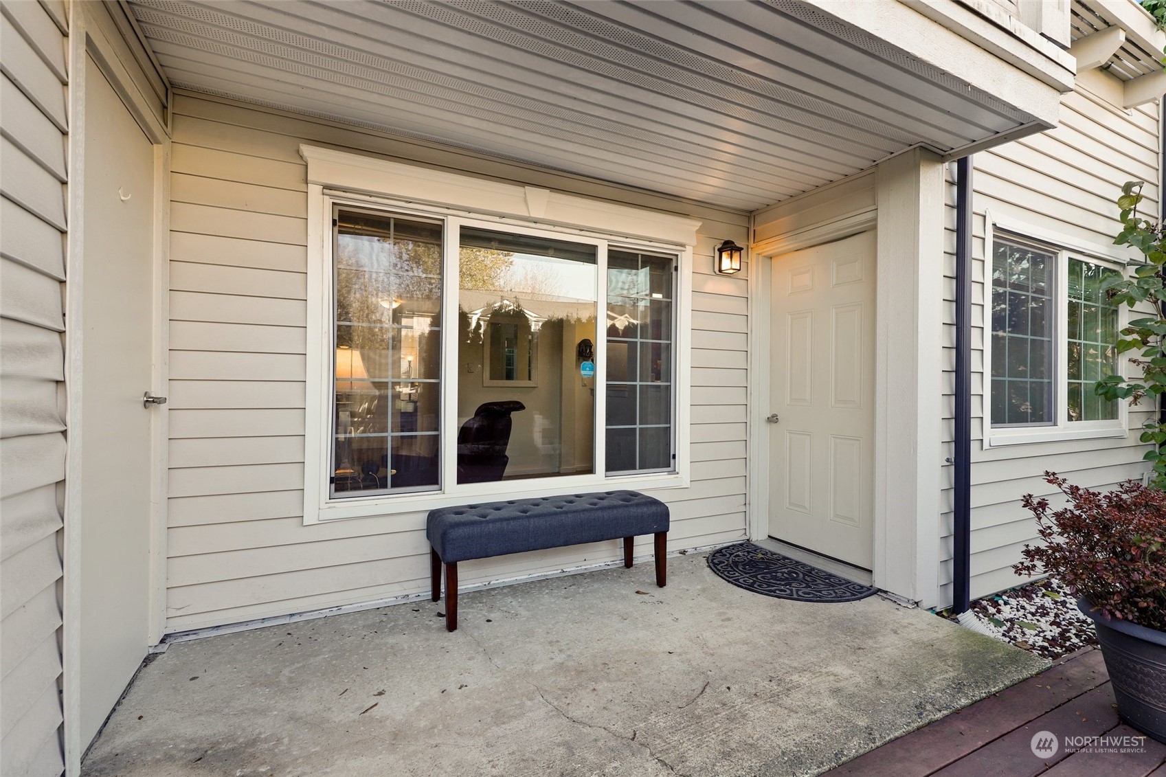 12404 East Gibson Road, Unit J103 Everett, WA 98204 - Photo 25 of 40 a building outdoor space with patio furniture and potted plants