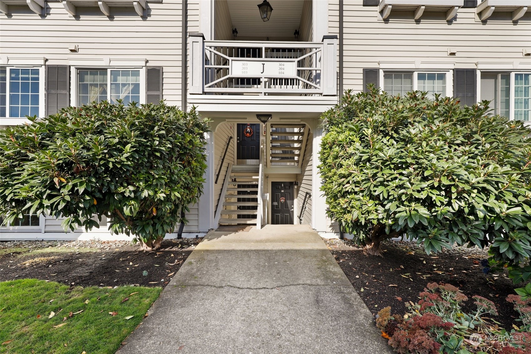 12404 East Gibson Road, Unit J103 Everett, WA 98204 - Photo 3 of 40 front view of a building with a yard