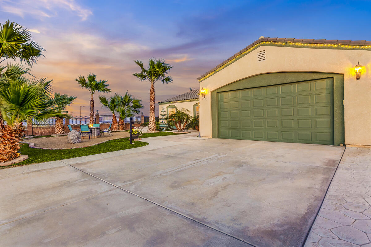 2902 Treadwell Boulevard Thermal, CA 92274 - Photo 2 of 88 a front view of a house with a yard and garage