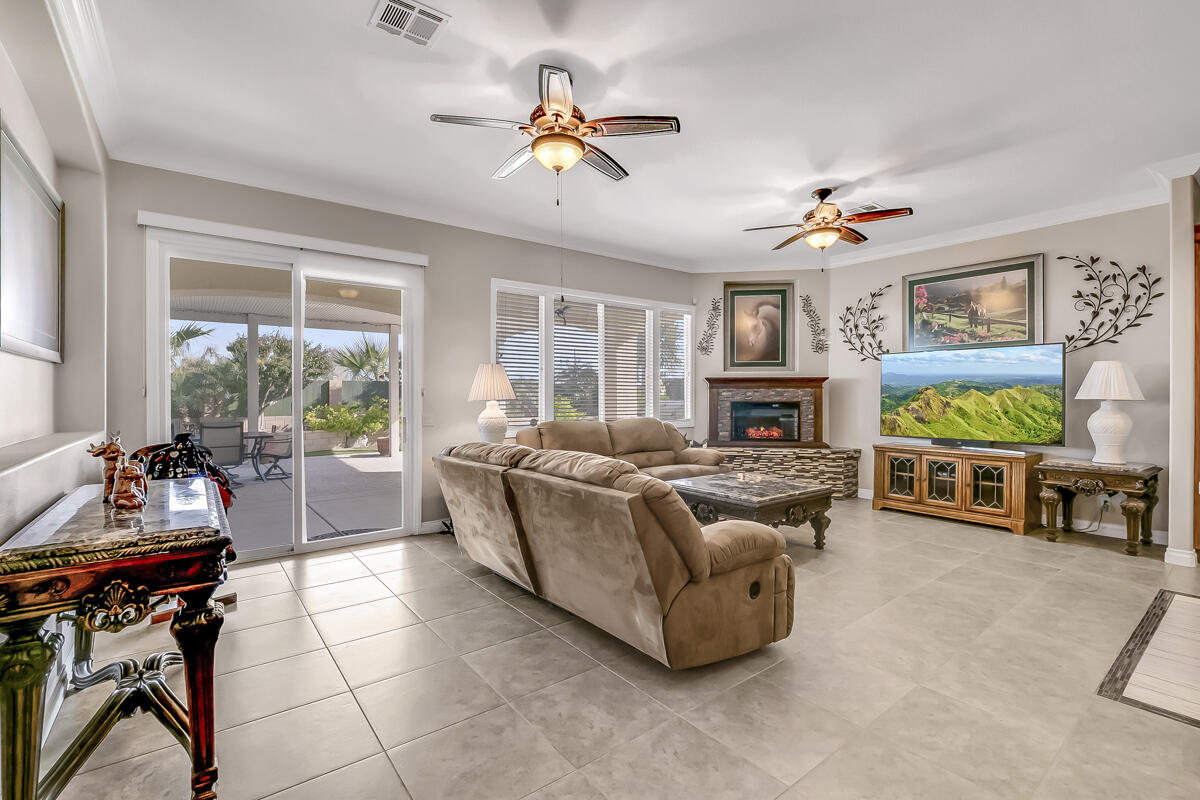 2902 Treadwell Boulevard Thermal, CA 92274 - Photo 39 of 88 a living room with furniture a fireplace and a flat screen tv