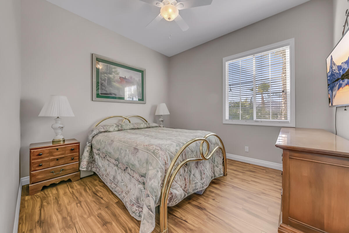 2902 Treadwell Boulevard Thermal, CA 92274 - Photo 51 of 88 a bedroom with a bed and a chandelier