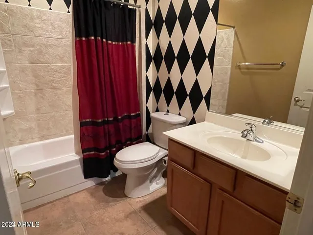 a view of a livingroom with wooden floor and chandelier
