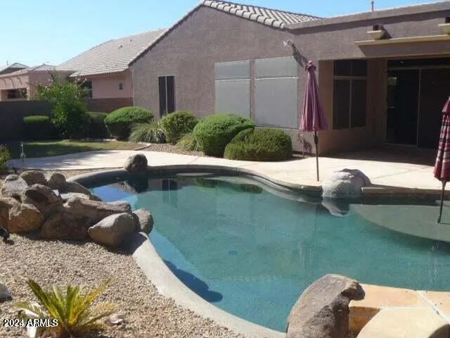 a view of empty room with windows and wardrobe