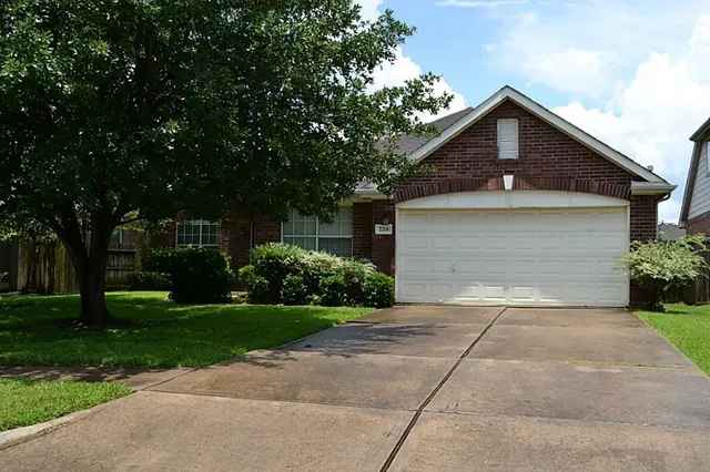 a front view of a house with a yard and a garage