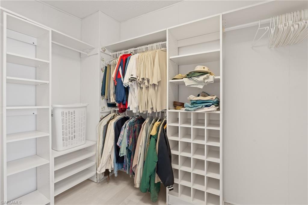 278 Riverwood Road Naples, FL 34114 - Photo 24 of 43 Spacious closet featuring wood finished floors