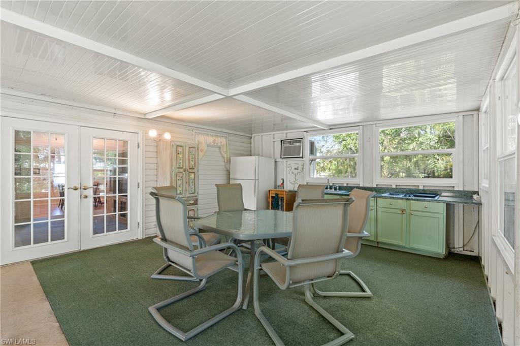 278 Riverwood Road Naples, FL 34114 - Photo 26 of 43 Sunroom featuring french doors and a wall unit AC