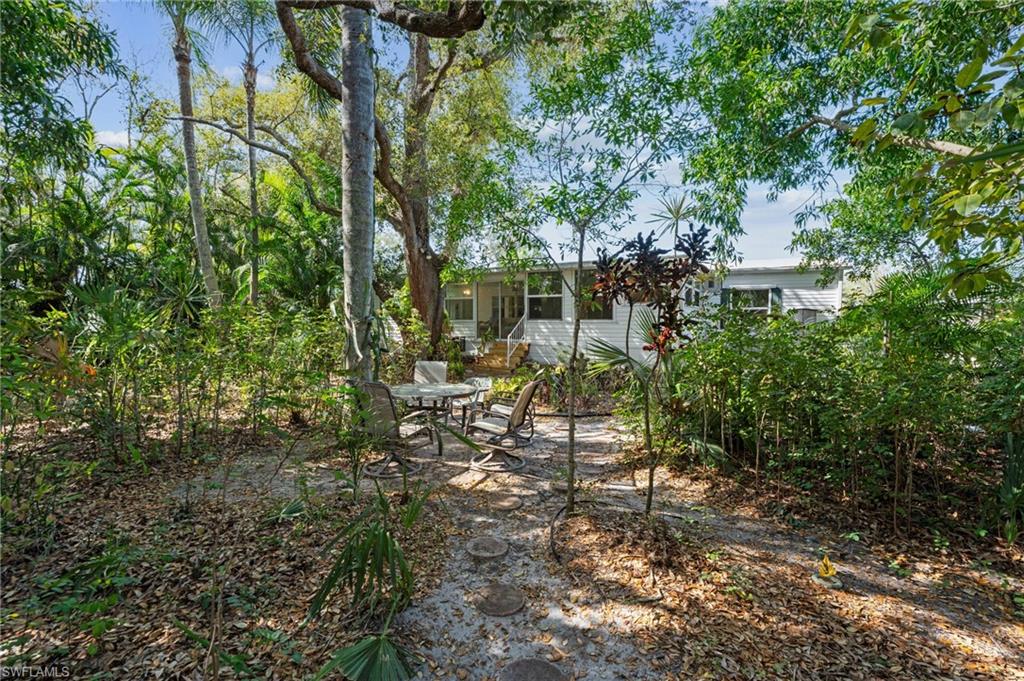 278 Riverwood Road Naples, FL 34114 - Photo 33 of 43 View of yard featuring entry steps