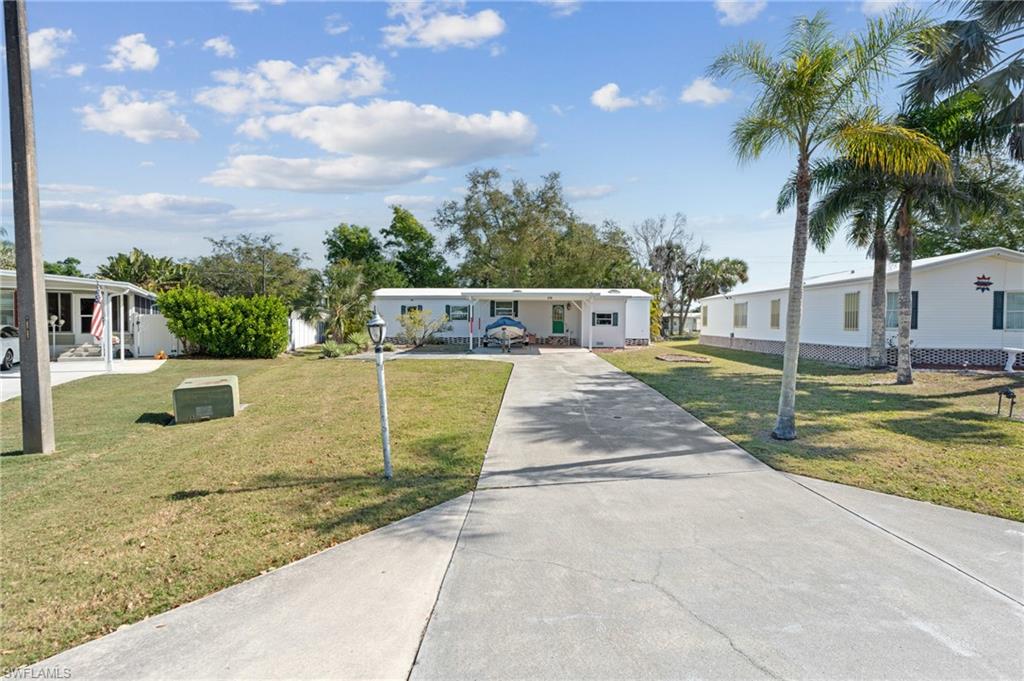 278 Riverwood Road Naples, FL 34114 - Photo 37 of 43 Manufactured / mobile home with a front yard and driveway