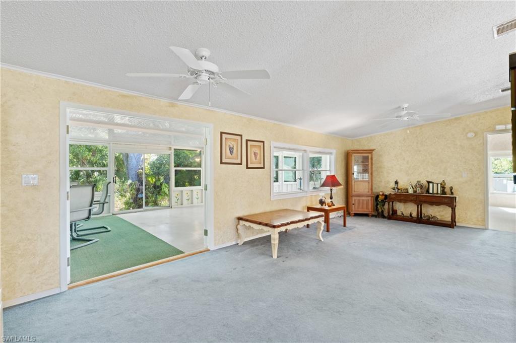 278 Riverwood Road Naples, FL 34114 - Photo 9 of 43 Miscellaneous room featuring visible vents, carpet floors, a textured wall, a textured ceiling, and a ceiling fan