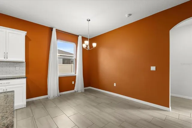 a view of a kitchen with a sink and a large window