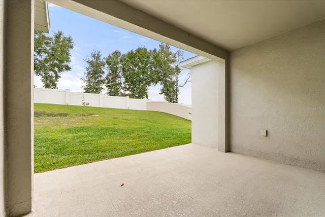 a backyard of a house with table and chairs