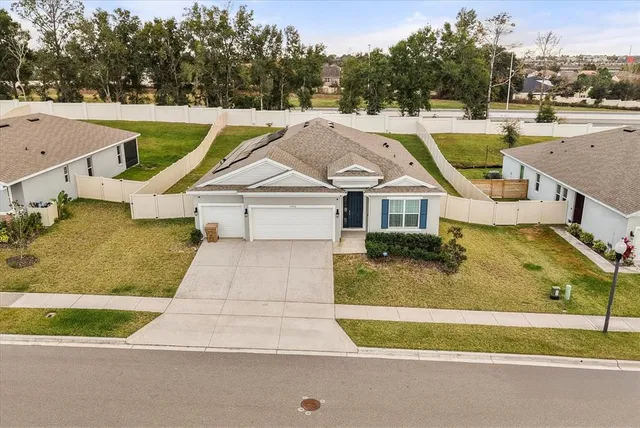 an aerial view of a house with a big yard