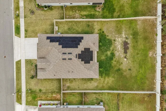 an aerial view of a house with a ocean view