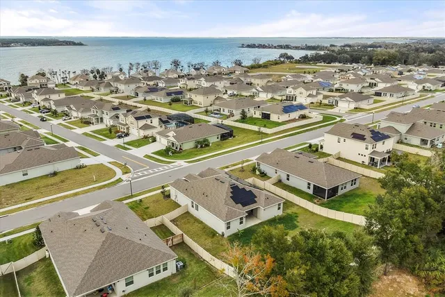 a view of a house with a big yard and potted plants