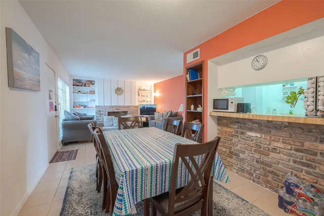 a view of a dining room with furniture and a floor to ceiling window
