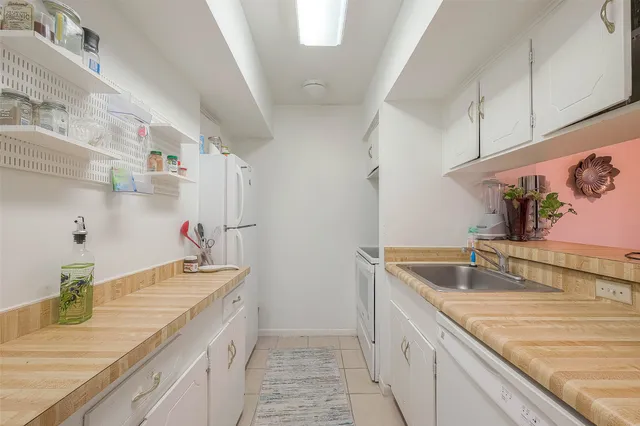 a kitchen with kitchen island a sink stove and refrigerator