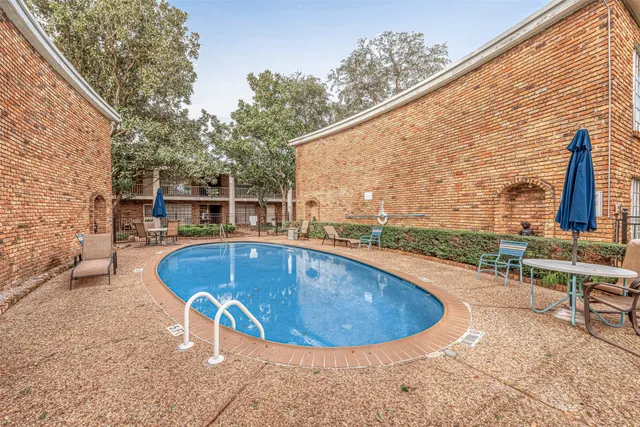 a view of outdoor space with swimming pool and sitting space