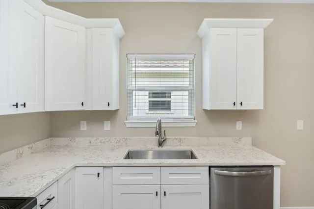 a kitchen with a sink and cabinets