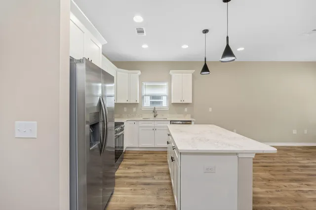 a kitchen with a refrigerator a sink and a stove