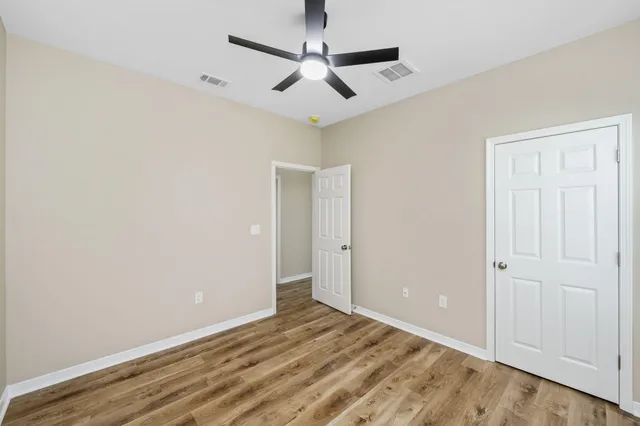 an empty room with a ceiling fan and a ceiling fan