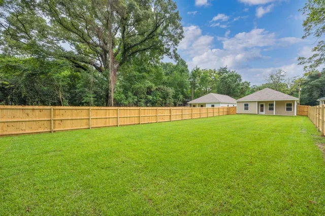 a view of field with trees in the background