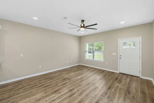 wooden floor in an empty room with a window