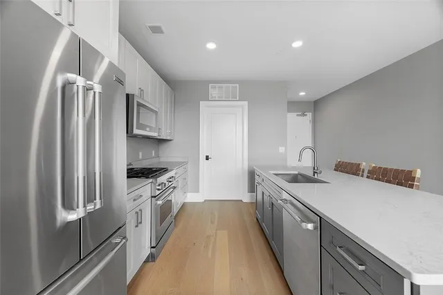 a kitchen with a sink stove and refrigerator