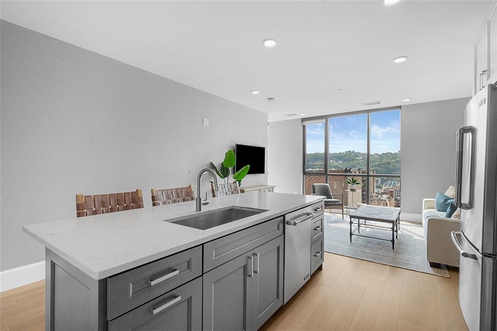 350 Oliver Avenue, Unit 1503 Pittsburgh, PA 15222 - Photo 13 of 43 a view of a kitchen with a sink and large window