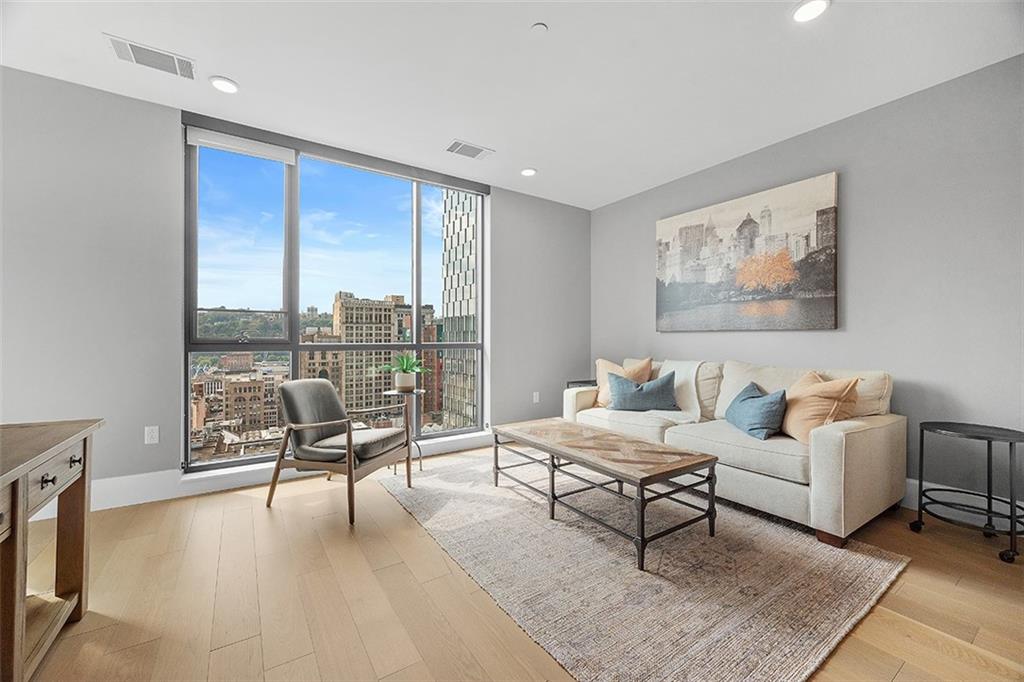350 Oliver Avenue, Unit 1503 Pittsburgh, PA 15222 - Photo 17 of 43 a living room with furniture and a large window
