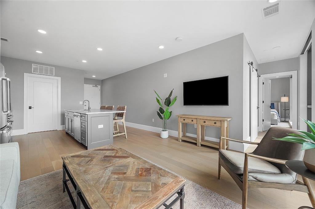 350 Oliver Avenue, Unit 1503 Pittsburgh, PA 15222 - Photo 20 of 43 a living room with furniture and a flat screen tv